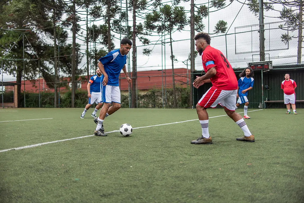 Soccer match with players in blue, red.