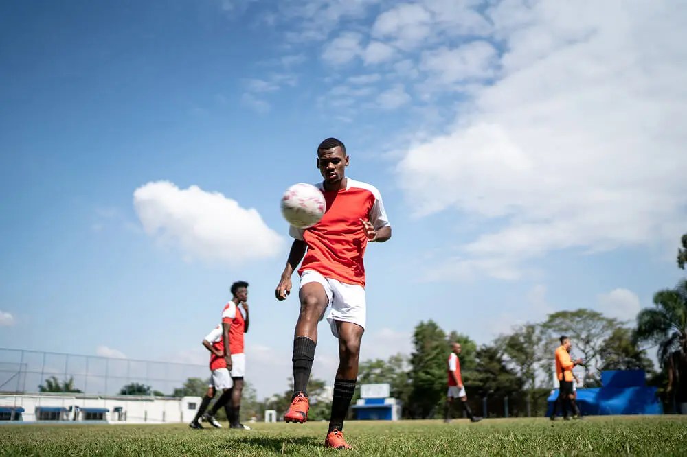 Soccer player juggling ball during practice.